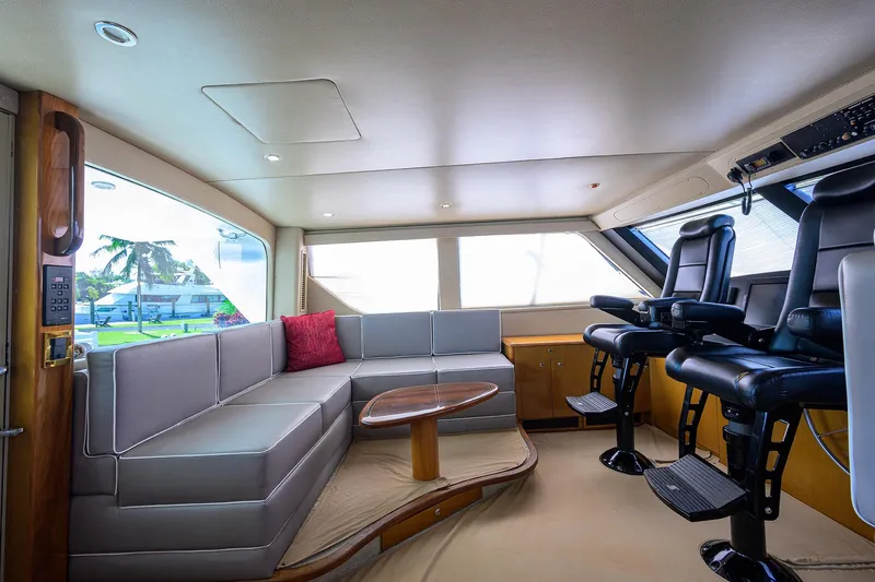 Slide: The Image of Luxurious interior of 2001 Viking 65 Enclosed Bridge yacht with plush seating and helm chairs. - 38