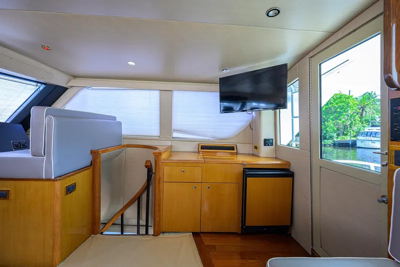 Slide: The Image of Interior of 2001 Viking 65 Enclosed Bridge yacht with modern furnishings and scenic window view. - 41