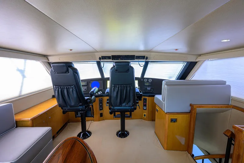 Slide: The Image of Interior of 2001 Viking 65 Enclosed Bridge yacht with helm and seating area. - 42