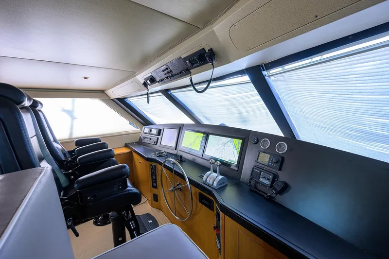 Slide: The Image of Interior of 2001 Viking 65 Enclosed Bridge yacht cockpit with navigation equipment. - 43