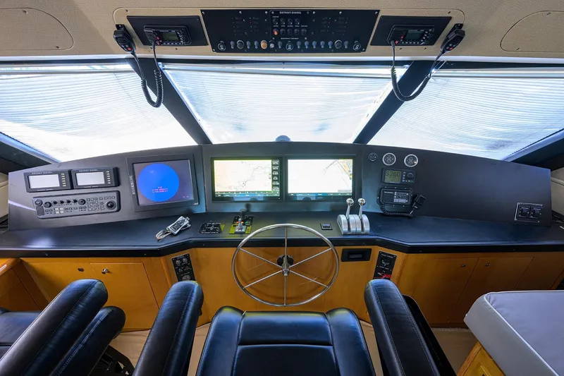 Slide: The Image of 2001 Viking 65 Enclosed Bridge yacht helm with navigation screens and controls. - 45