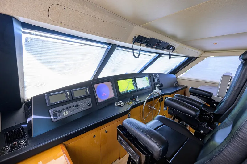 Slide: The Image of Interior helm of 2001 Viking 65 Enclosed Bridge yacht with navigation equipment and leather seating. - 47