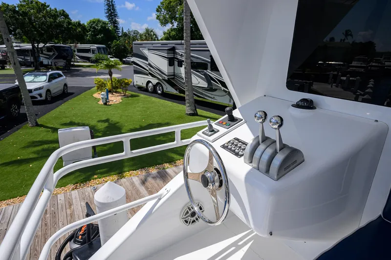 Slide: The Image of Control panel of a 2001 Viking 65 Enclosed Bridge yacht, with steering wheel and throttle levers. - 50