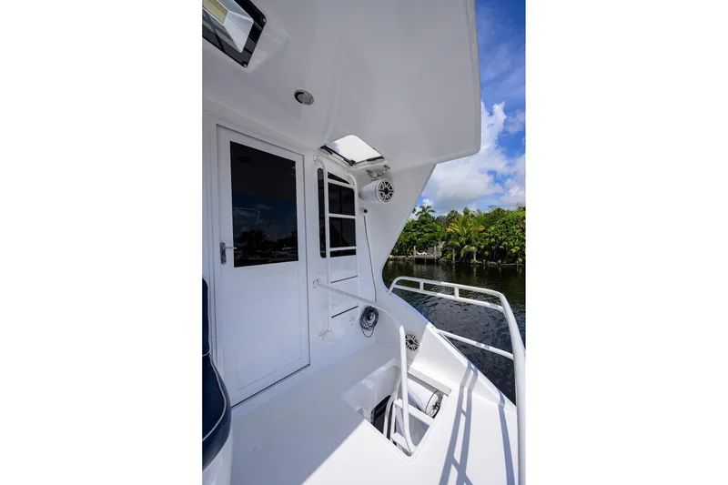 Slide: The Image of 2001 Viking 65 Enclosed Bridge yacht deck with white exterior and water view. - 52