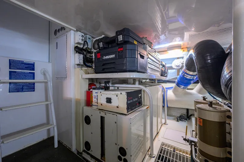 Slide: The Image of Engine room of 2001 Viking 65 Enclosed Bridge yacht with tools and equipment. - 57