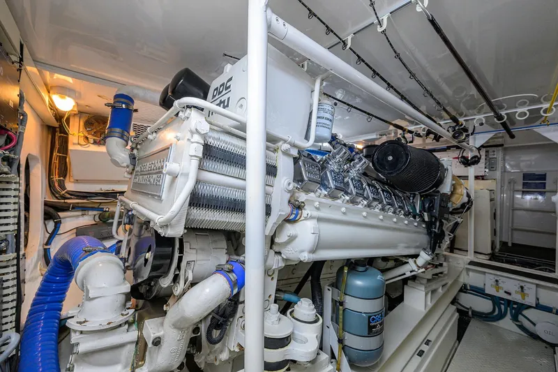 Slide: The Image of Engine room of 2001 Viking 65 Enclosed Bridge yacht, showcasing powerful machinery and components. - 58