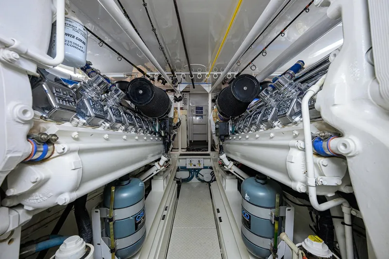 Slide: The Image of Engine room of 2001 Viking 65 Enclosed Bridge yacht, showcasing dual engines and mechanical components. - 60