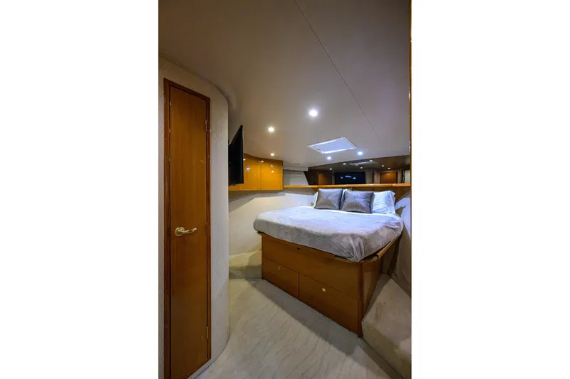 Slide: The Image of Luxurious bedroom interior of 2001 Viking 65 Enclosed Bridge yacht with cozy bedding. - 63