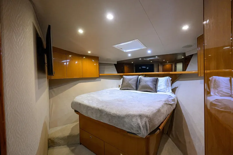 Slide: The Image of Luxurious bedroom interior of 2001 Viking 65 Enclosed Bridge yacht with modern lighting. - 64