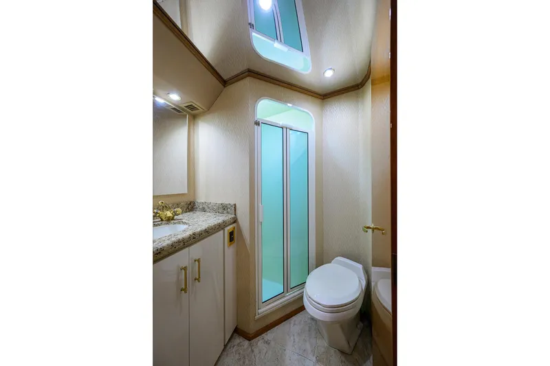 Slide: The Image of Luxurious bathroom in 2001 Viking 65 Enclosed Bridge yacht with shower and granite countertop. - 67