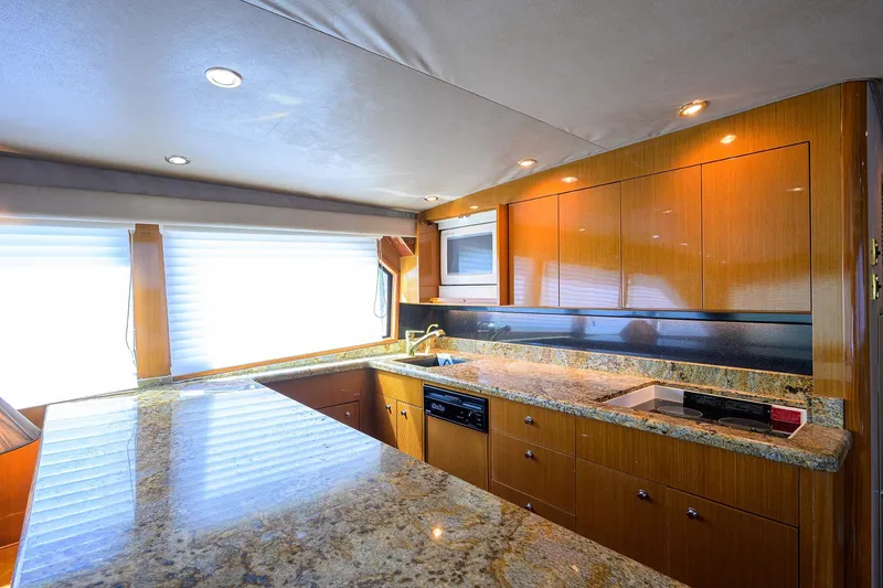 Slide: The Image of Luxurious kitchen interior of 2001 Viking 65 Enclosed Bridge yacht with granite countertops. - 72