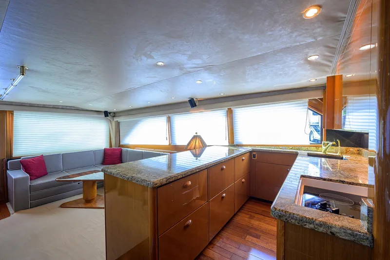 Slide: The Image of Luxurious interior of 2001 Viking 65 Enclosed Bridge yacht with modern kitchen and seating area. - 73