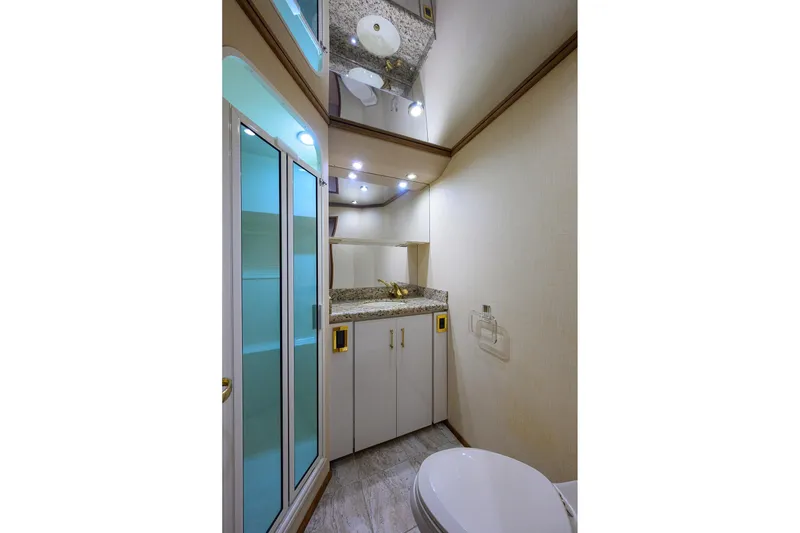 Slide: The Image of Luxurious bathroom in 2001 Viking 65 Enclosed Bridge yacht with granite countertop and shower. - 78