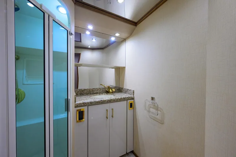 Slide: The Image of Luxurious bathroom interior of 2001 Viking 65 Enclosed Bridge yacht with granite countertop. - 79