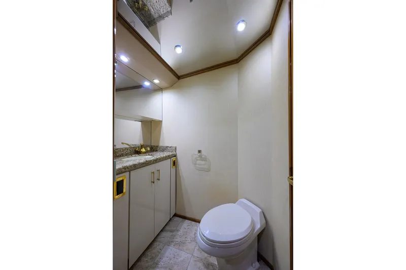 Slide: The Image of Luxurious bathroom in 2001 Viking 65 Enclosed Bridge yacht with granite countertop. - 80
