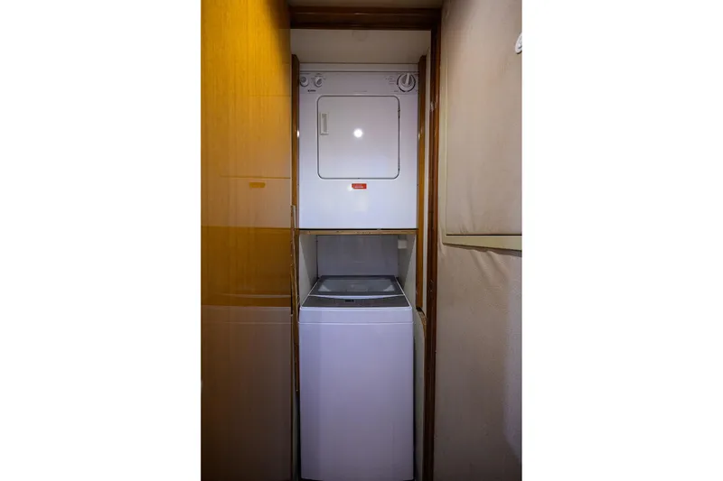 Slide: The Image of Stacked washer and dryer in 2001 Viking 65 Enclosed Bridge yacht interior. - 81