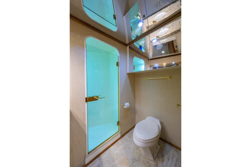Slide: The Image of Luxurious bathroom in 2001 Viking 65 Enclosed Bridge yacht, featuring shower and toilet. - 89