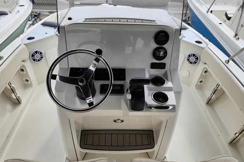 Slide: The Image of 2023 Stingray 206cc boat dashboard with steering wheel and control panel. - 10