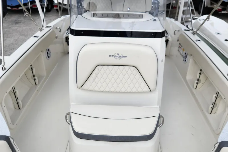 Slide: The Image of 2023 Stingray 206cc boat interior with white seating and console. - 12