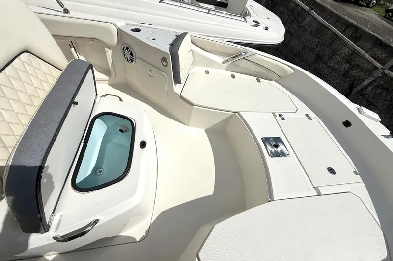 Slide: The Image of 2023 Stingray 206cc boat interior with seating and storage compartments. - 13