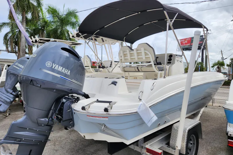 Slide: The Image of 2023 Stingray 206cc boat with Yamaha outboard motor, parked on a trailer. - 4