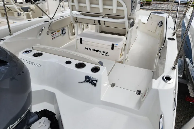 Slide: The Image of 2023 Stingray 206cc boat interior with seating, storage, and motor details. - 5