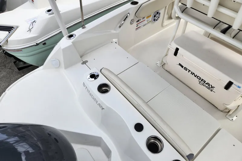 Slide: The Image of 2023 Stingray 206cc boat interior with seating and storage compartments. - 6