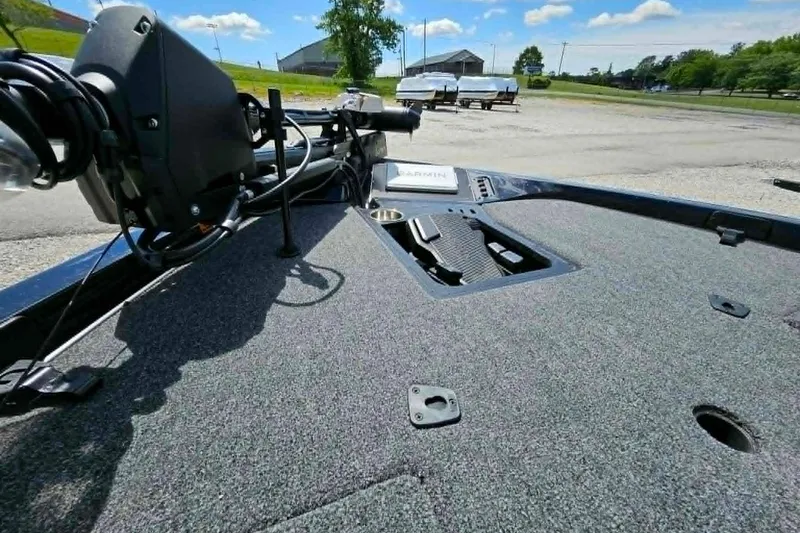 Slide: The Image of 2025 Ranger Z518 Cup-Equipped boat deck with Garmin equipment, parked outdoors. - 10