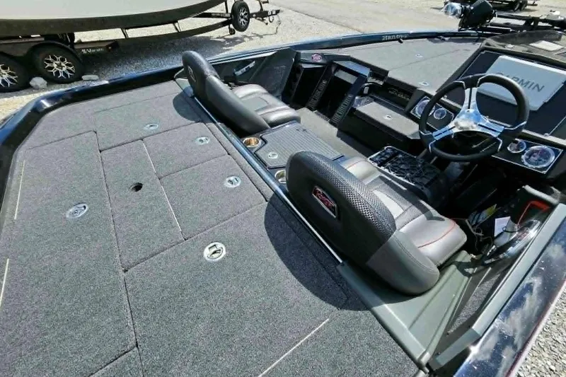 Slide: The Image of 2025 Ranger Z518 Cup-Equipped boat interior with steering wheel and seating. - 12