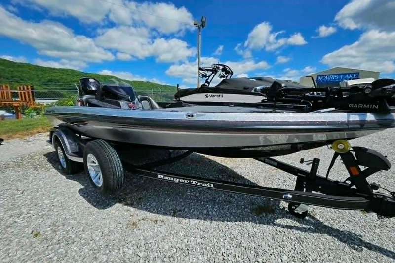 Slide: The Image of 2025 Ranger Z518 Cup-Equipped boat on trailer, parked outdoors under blue sky. - 13