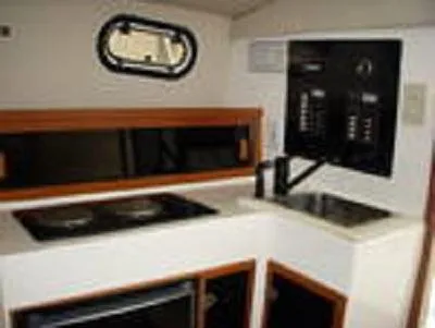 Slide: The Image of 1998 Rampage 28 Express boat interior with kitchenette and control panel. - 12