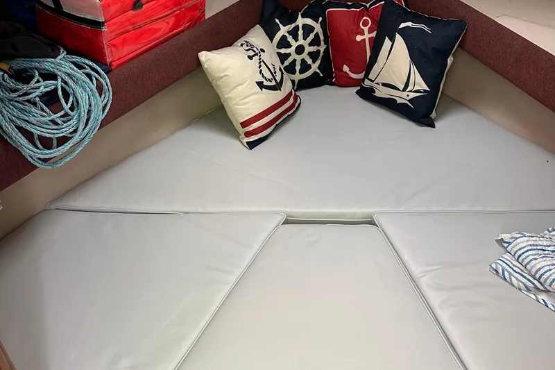 Slide: The Image of Cozy cabin interior of 1998 Rampage 28 Express with nautical-themed pillows. - 13