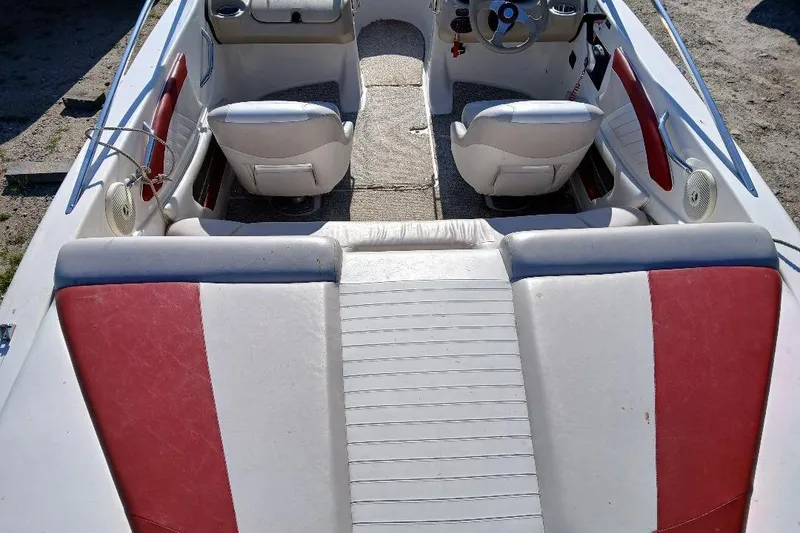 Slide: The Image of 2007 Glastron GT 185 boat interior with red and white seating, steering wheel, and controls. - 2