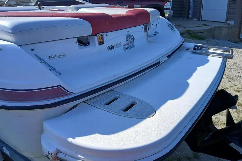 Slide: The Image of 2007 Glastron GT 185 boat rear view with swim platform and red-white seating. - 4