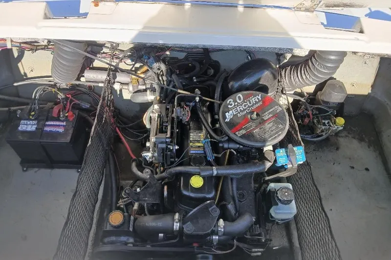 Slide: The Image of 2007 Glastron GT 185 engine compartment with Mercury MerCruiser 3.0 motor and battery. - 5