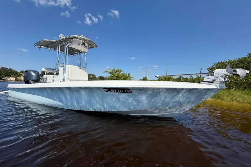 The Image of 2024 Contender 26 Bay boat on water, clear sky background. - 0