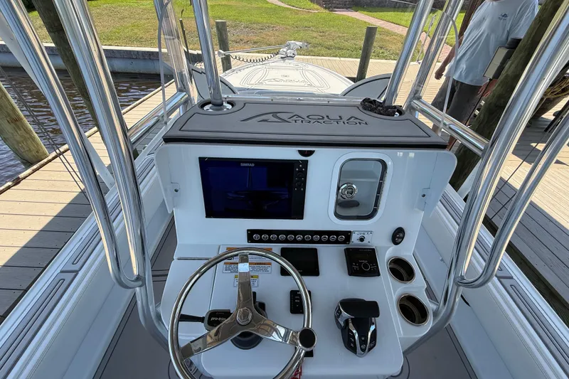 Slide: The Image of 2024 Contender 26 Bay boat console with steering wheel, controls, and navigation display. - 19