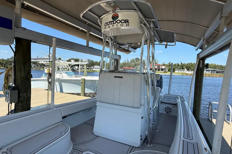 Slide: The Image of 2024 Contender 26 Bay boat docked, featuring sleek design and spacious interior. - 24