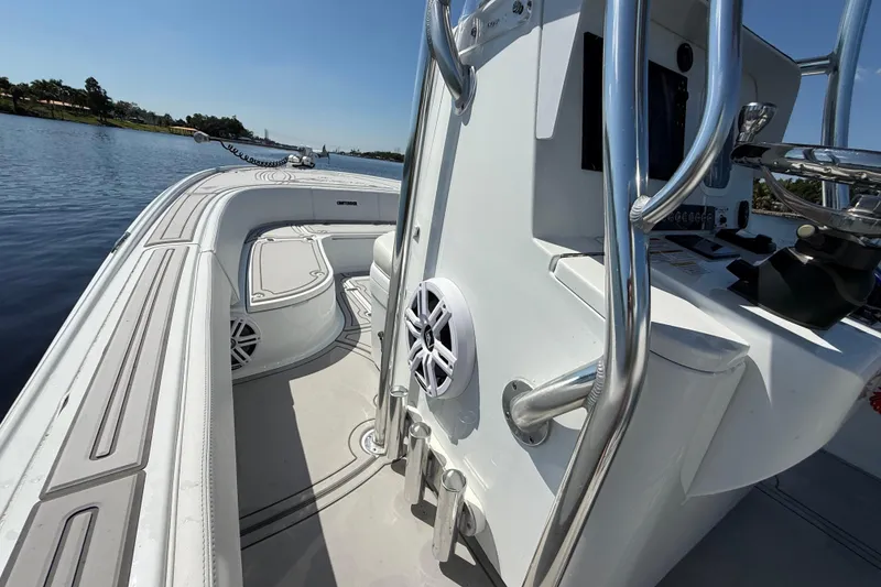Slide: The Image of 2024 Contender 26 Bay boat interior with sleek design and modern features on a calm waterway. - 35