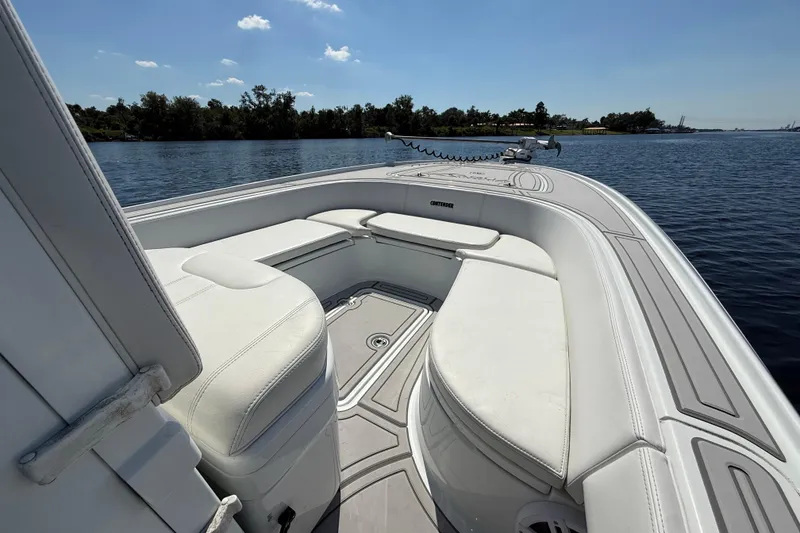 Slide: The Image of 2024 Contender 26 Bay boat interior with white seating on calm water. - 41