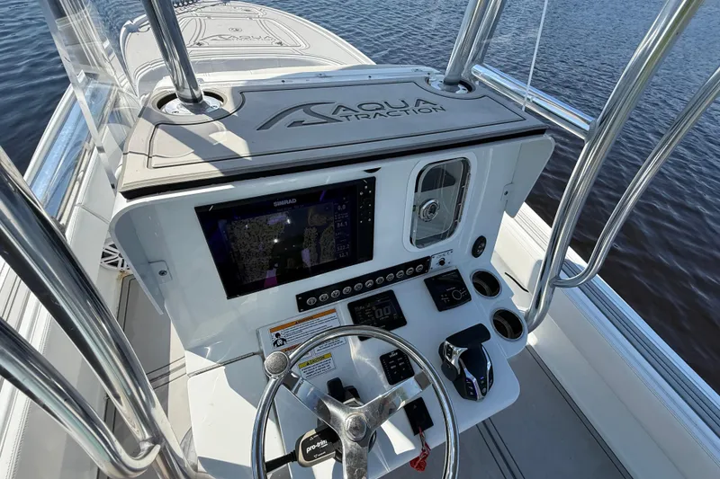 Slide: The Image of 2024 Contender 26 Bay boat console with navigation system and steering wheel. - 45