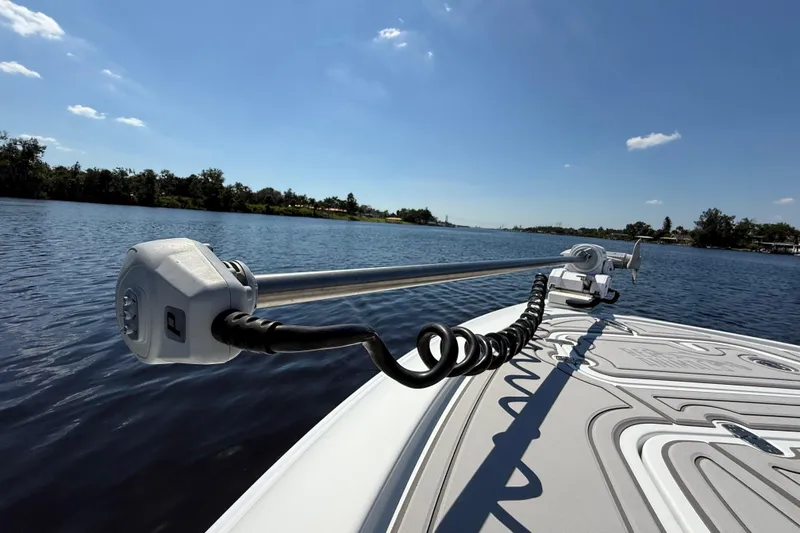 Slide: The Image of 2024 Contender 26 Bay boat on a serene lake under a clear blue sky. - 46