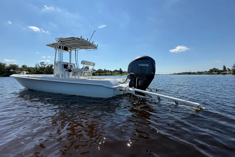 Slide: The Image of 2024 Contender 26 Bay boat with Yamaha engine on calm water. - 5