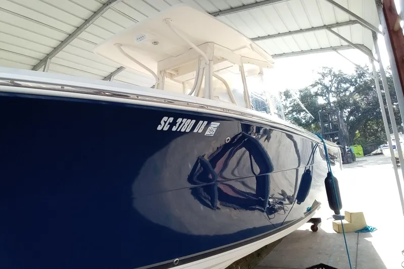 Slide: The Image of 2014 Cobia 296 Center Console boat in a covered storage area. - 11