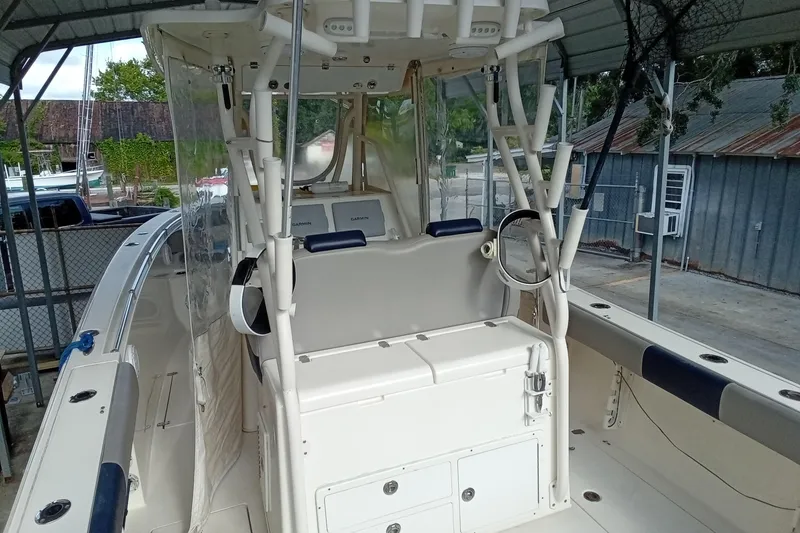 Slide: The Image of 2014 Cobia 296 Center Console boat interior with helm and seating area. - 12