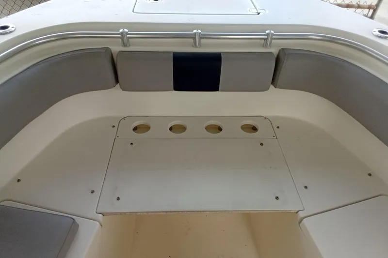 Slide: The Image of 2014 Cobia 296 Center Console boat interior with cushioned seating and rod holders. - 15