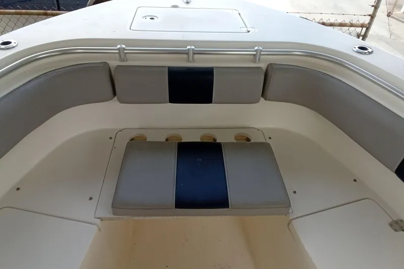 Slide: The Image of 2014 Cobia 296 Center Console boat interior with cushioned seating and storage compartments. - 17