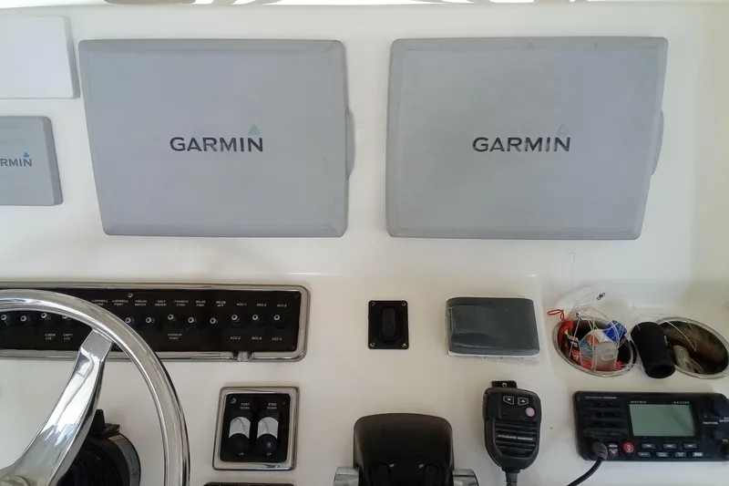 Slide: The Image of 2014 Cobia 296 Center Console helm with Garmin displays and controls. - 24