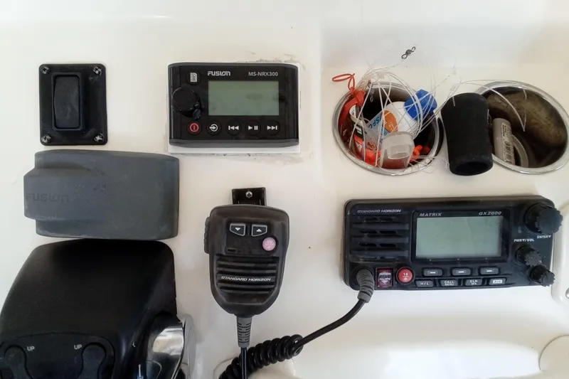 Slide: The Image of 2014 Cobia 296 Center Console dashboard with radio, controls, and storage compartment. - 25