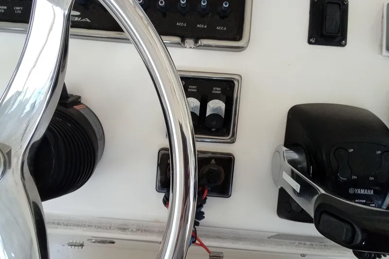 Slide: The Image of Steering wheel and controls of 2014 Cobia 296 Center Console boat. - 26